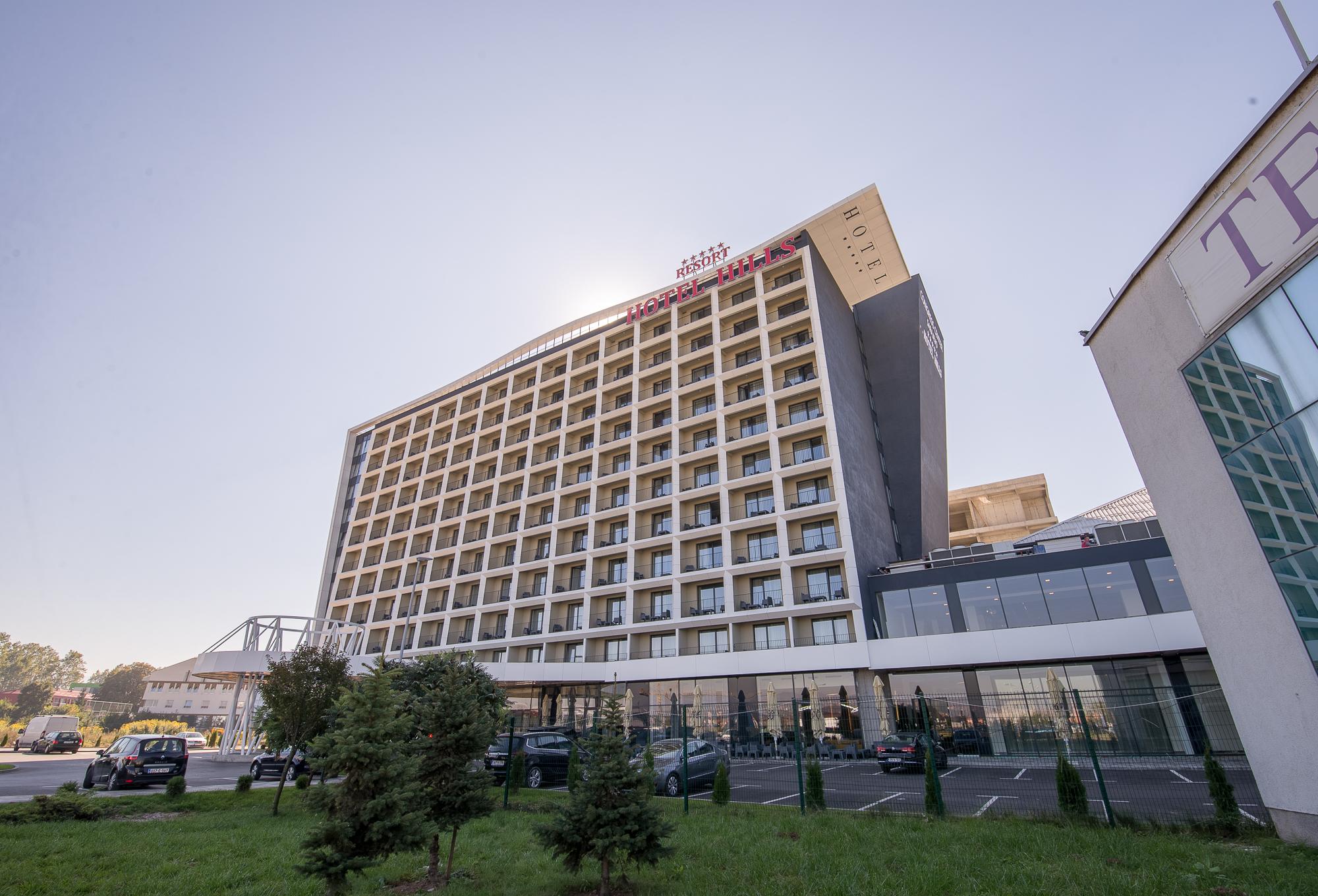 Hotel Hills Sarajevo Congress & Thermal Spa Resort Ilidža Екстериор снимка The photo shows a modern hotel building with multiple floors and a contemporary design. The structure features large windows arranged in a grid pattern and a prominent entrance area at the bottom. There are green areas, possibly with trees or landsca